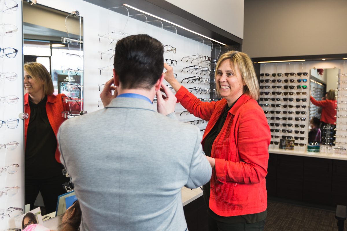 Man trying on frames in store